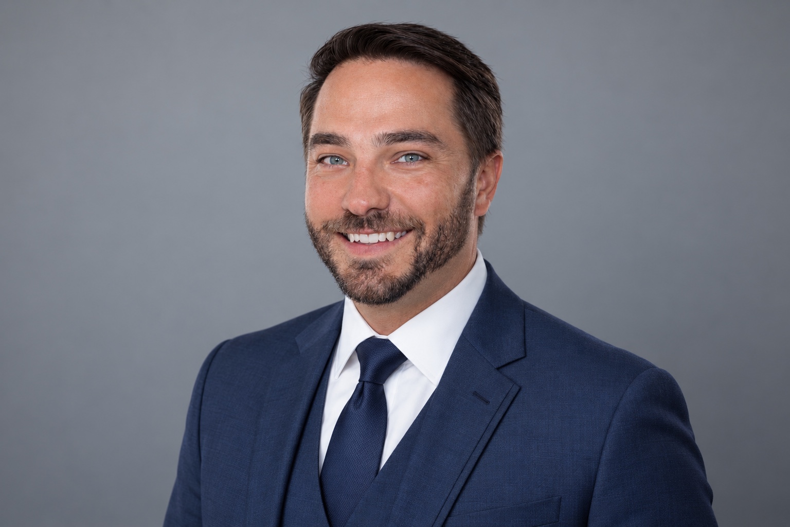 Jonathan Paschal smiling in a navy suit